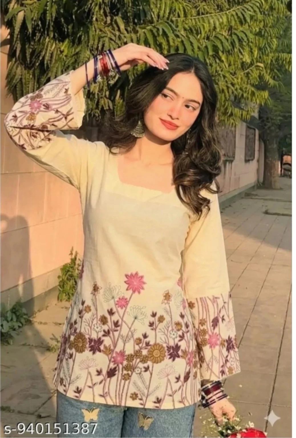 Cream floral top styled with blue denim in warm afternoon light